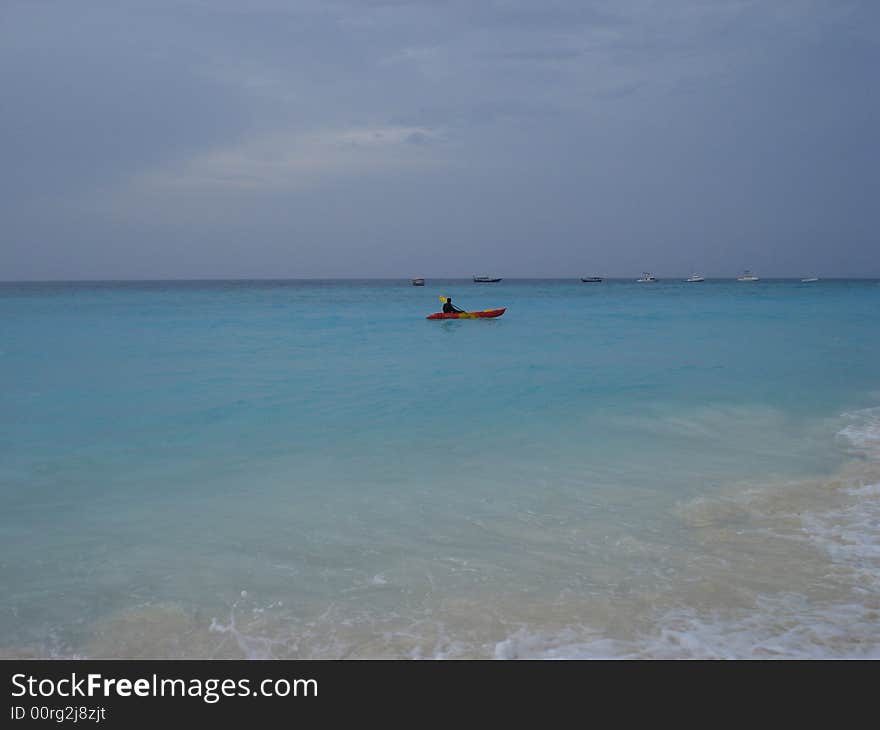 Red canoe floating in the ocean