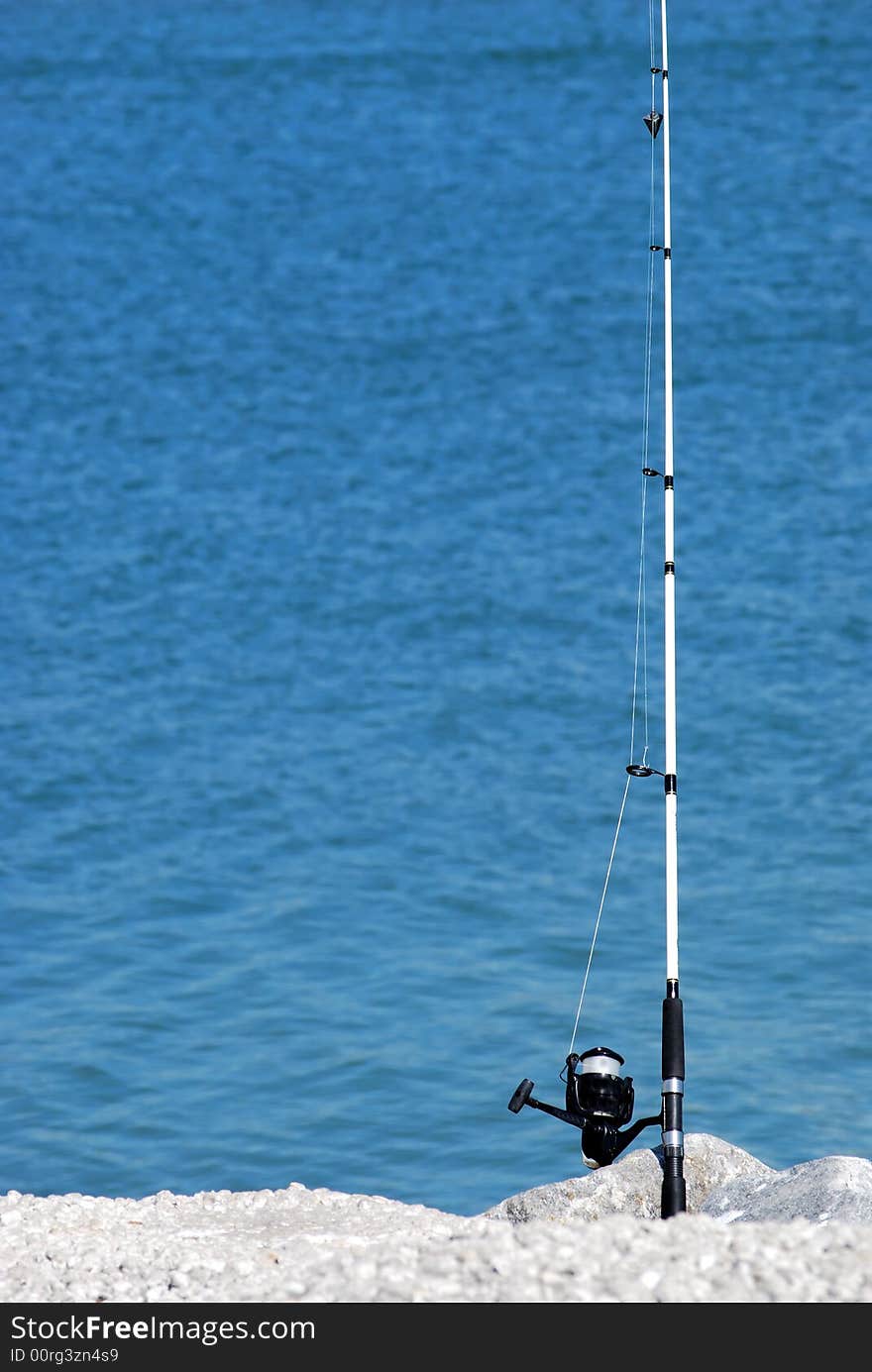 Fishing pole with a line in the water. Fishing pole with a line in the water