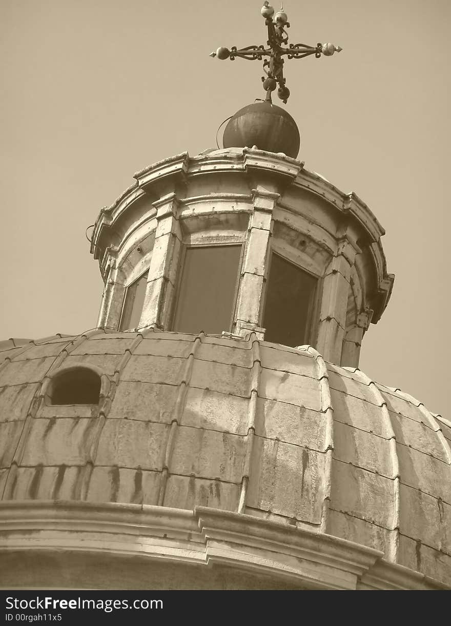 Church cupola with cross, looking up view, sepia image