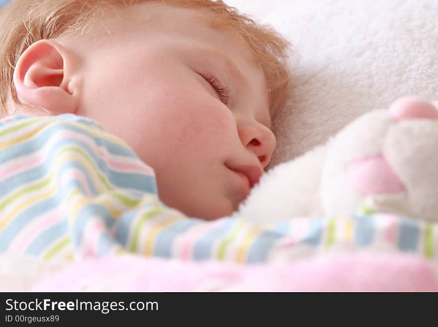 The small beautiful boy sleeps a head on a pillow. The small beautiful boy sleeps a head on a pillow