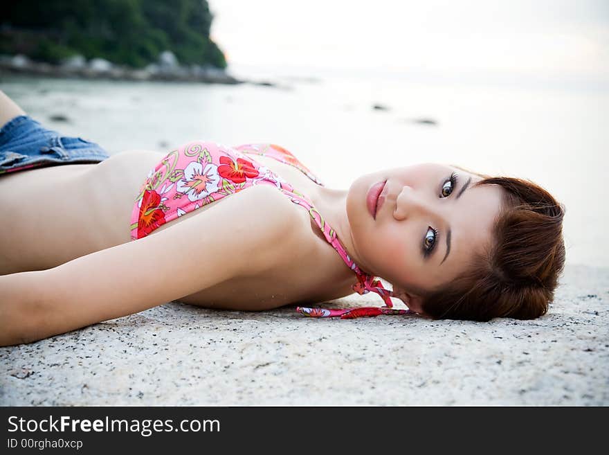 Woman lying on the sunset beach with bikini top. Woman lying on the sunset beach with bikini top