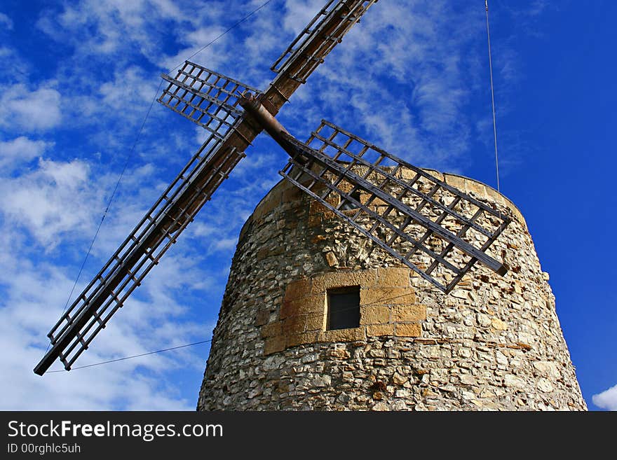 An image of a classic mill with a blue sky