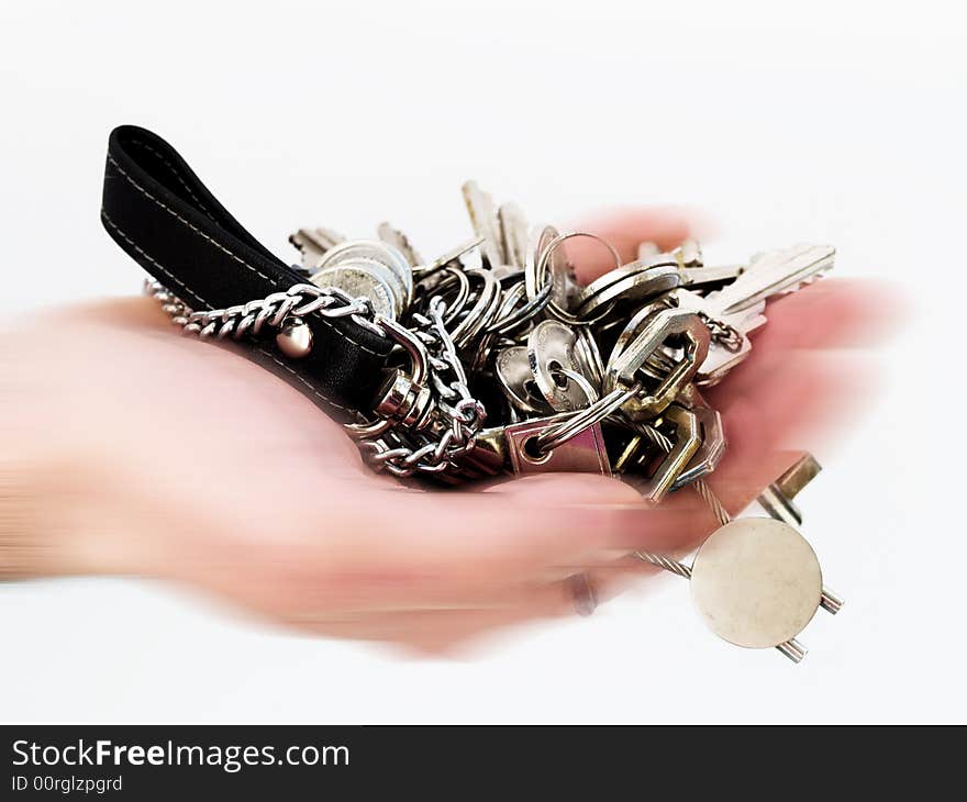 Hand in motion holding many keys. Hand in motion holding many keys