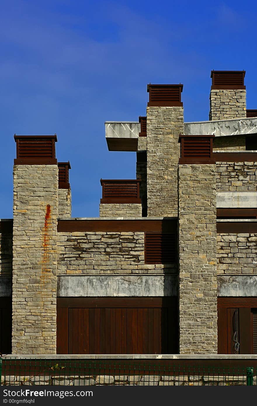 An image of a modern building with many chimneys.