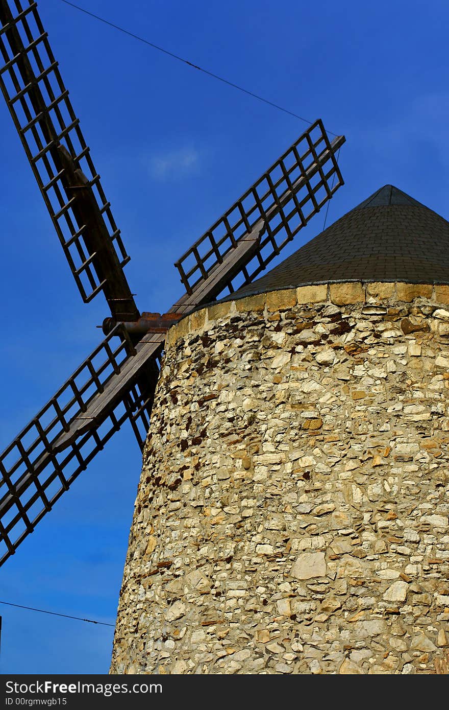 An image of a classic mill with a blue sky