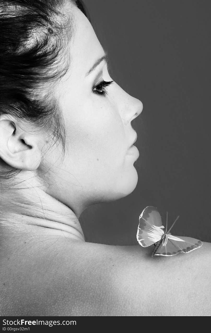 Beauty portrait of a beautiful young woman with a butterfly on her face. Beauty portrait of a beautiful young woman with a butterfly on her face