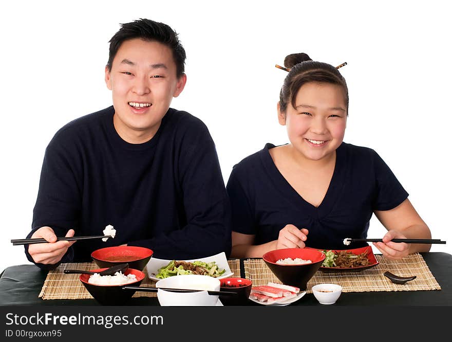 Father and daughter eat the asian food.