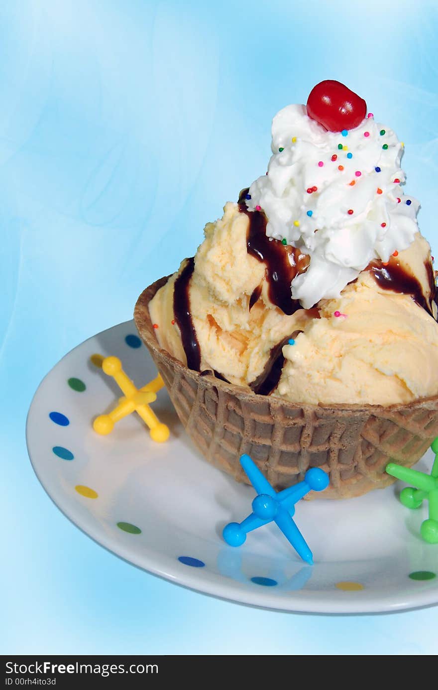 Hot fudge sundae in a waffle bowl with toy jacks. Hot fudge sundae in a waffle bowl with toy jacks.