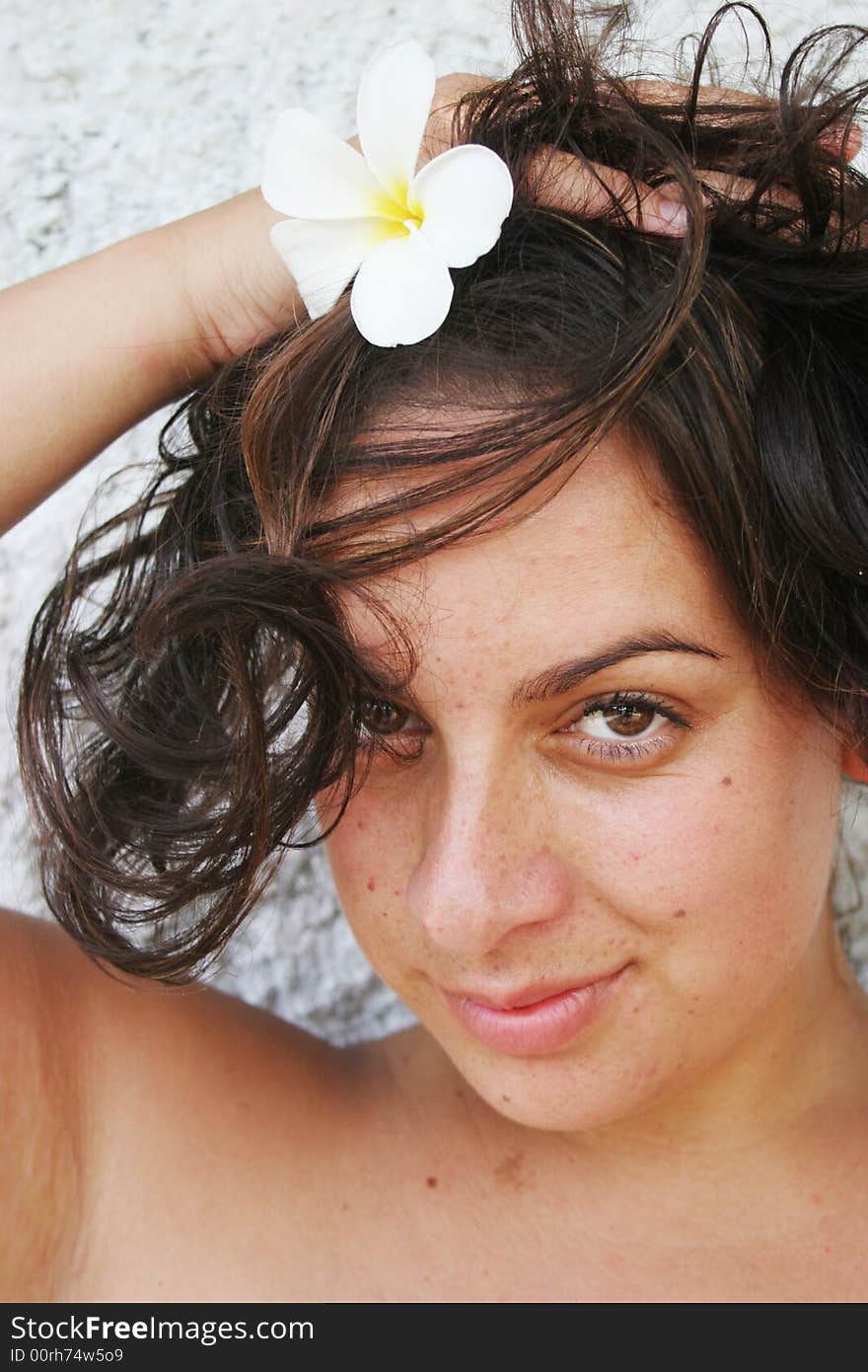 Close-up portrait of an attractive young woman holding her hair up. Close-up portrait of an attractive young woman holding her hair up.