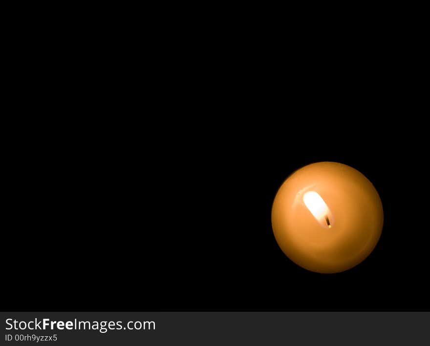 Solitary candle burning in a corner. Solitary candle burning in a corner