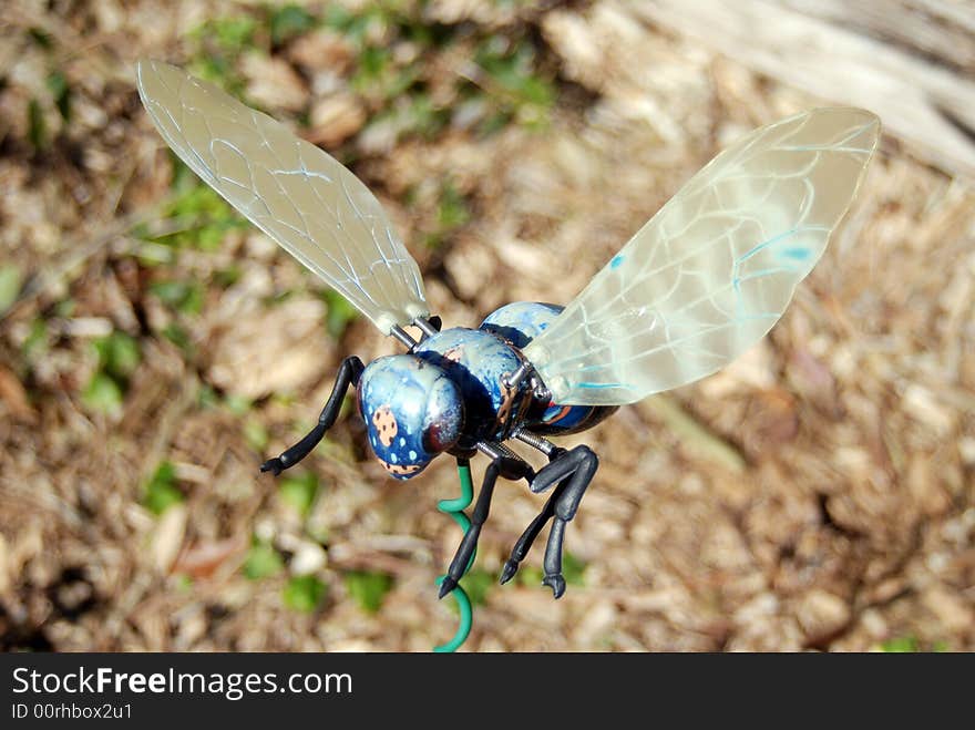 Superfly stuck with a stick in the garden for an ornamental decoration.