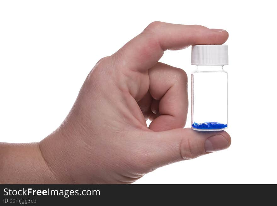 Man's hand holds a vial with blue crystal. Isolated on white [with clipping path]. Man's hand holds a vial with blue crystal. Isolated on white [with clipping path].