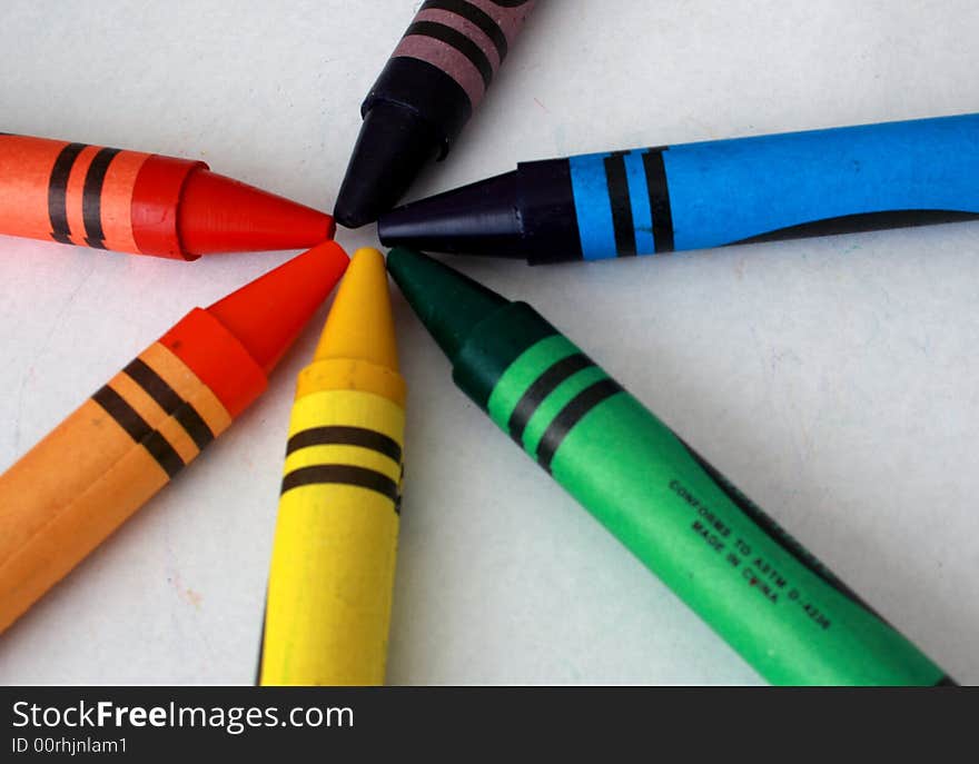 Colorful assorted crayons on a white background