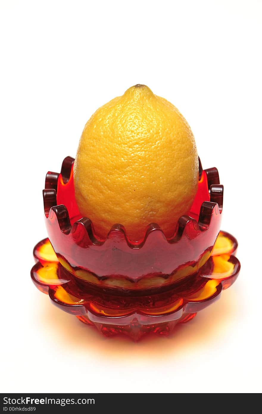 Red glass souvenir with lemon on the white background. Red glass souvenir with lemon on the white background