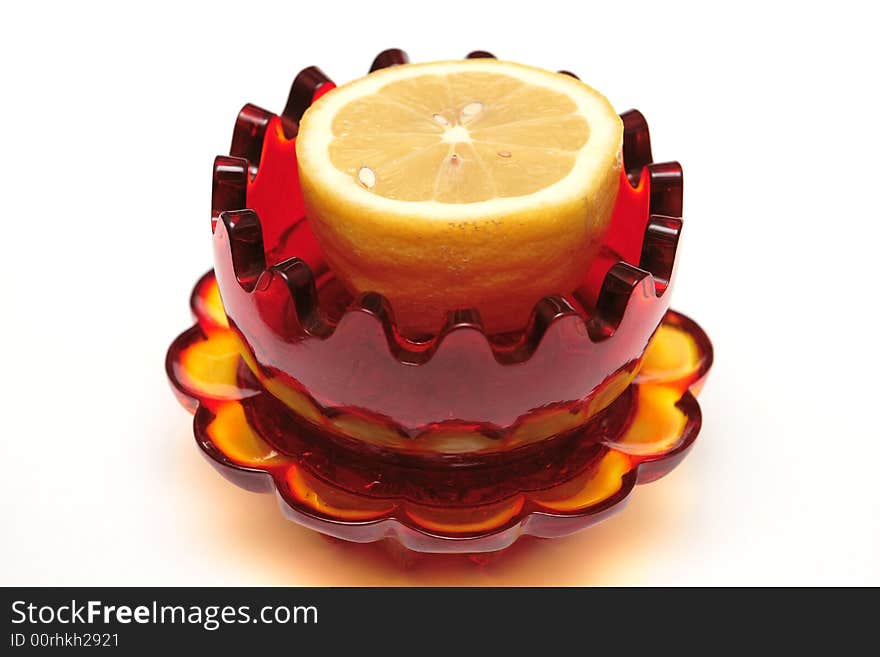 Red glass souvenir with lemon on the white background. Red glass souvenir with lemon on the white background