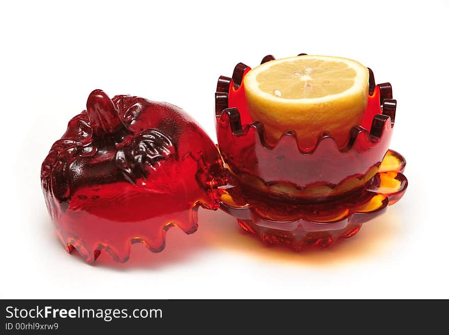 Red glass souvenir with lemon on the white background. Red glass souvenir with lemon on the white background