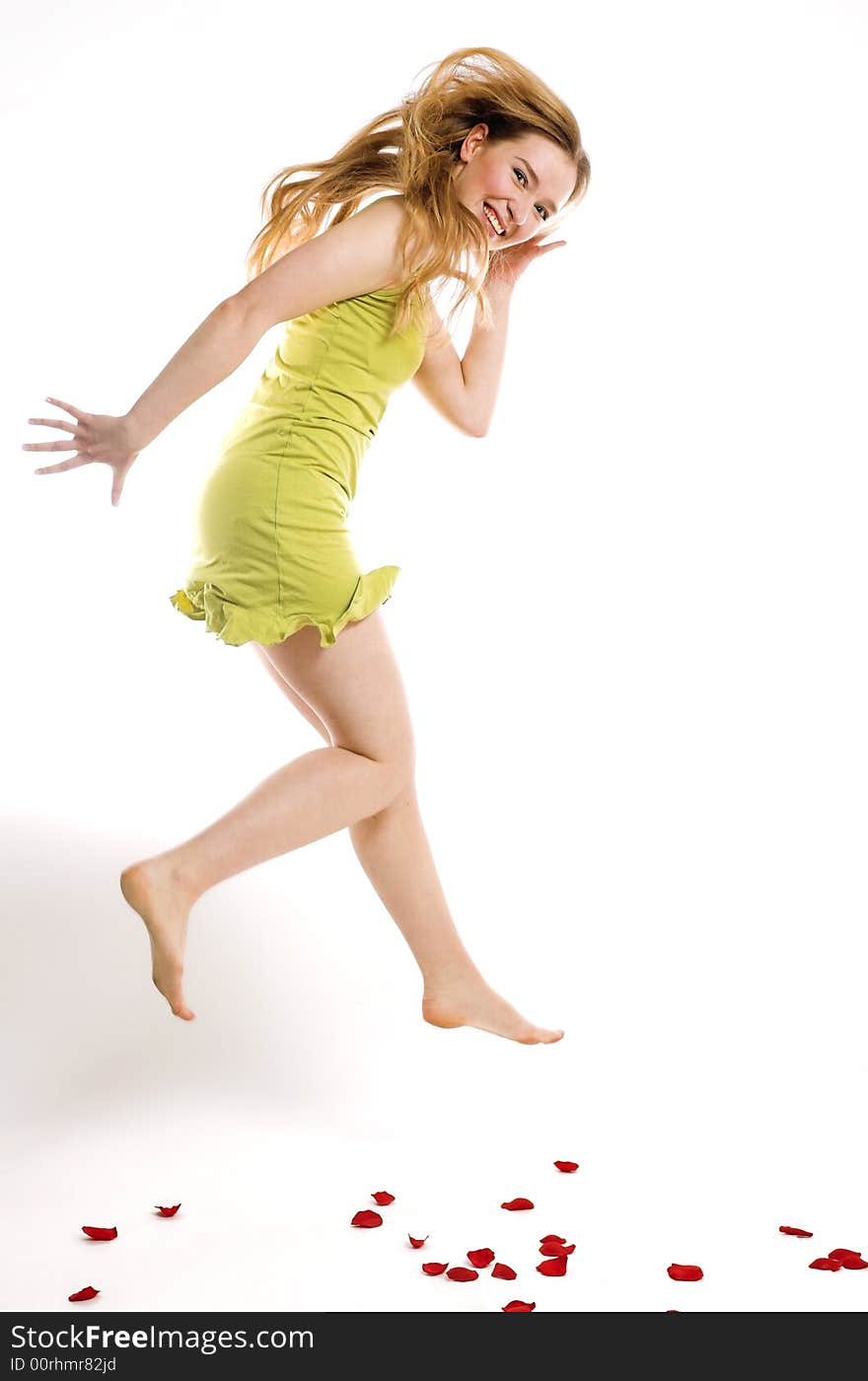 The cheerful blonde jumps on a white background