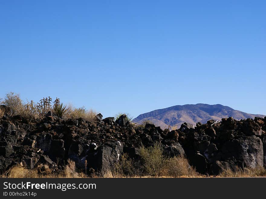 Lava Rocks With Mountain