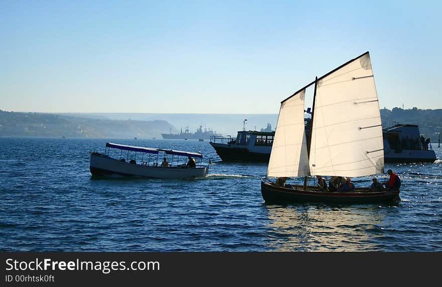 Yacht, boat and jolly boat in a bay of the black sea. Yacht, boat and jolly boat in a bay of the black sea