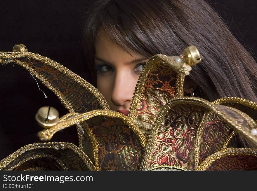 Young brunette girl in red with Venice carnival mask on black background. Young brunette girl in red with Venice carnival mask on black background.