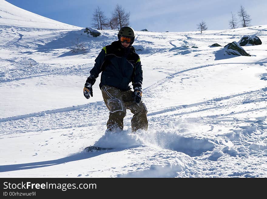 The snowboarder on a background of the blue sky