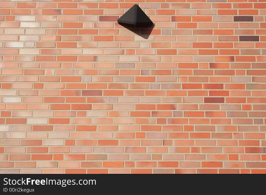 Red brick wall with a reflector