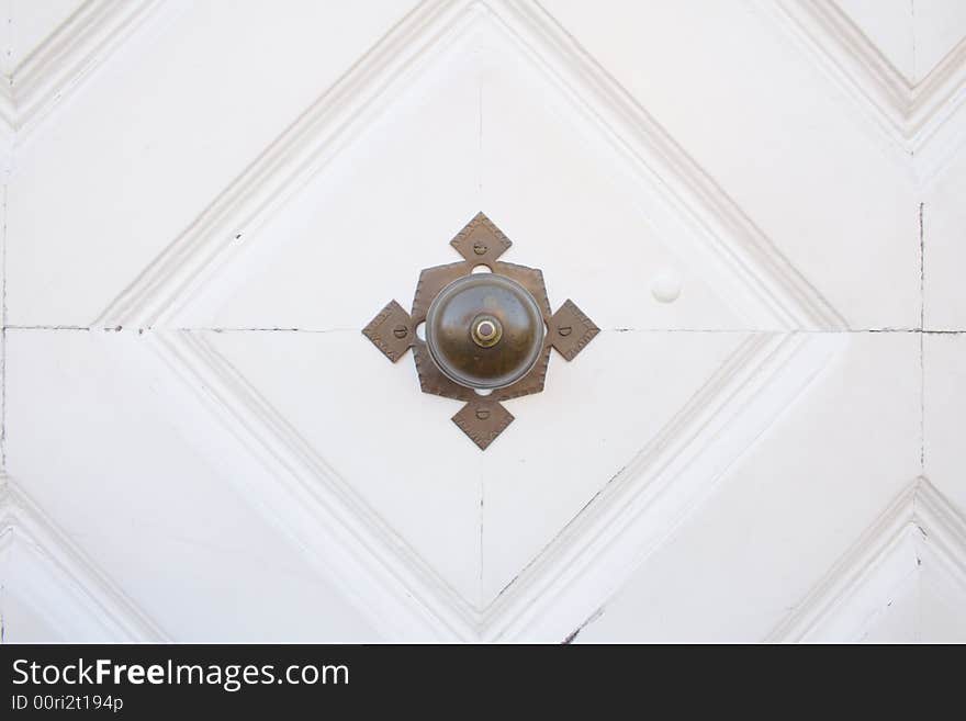 Door handle on a white door, close-up