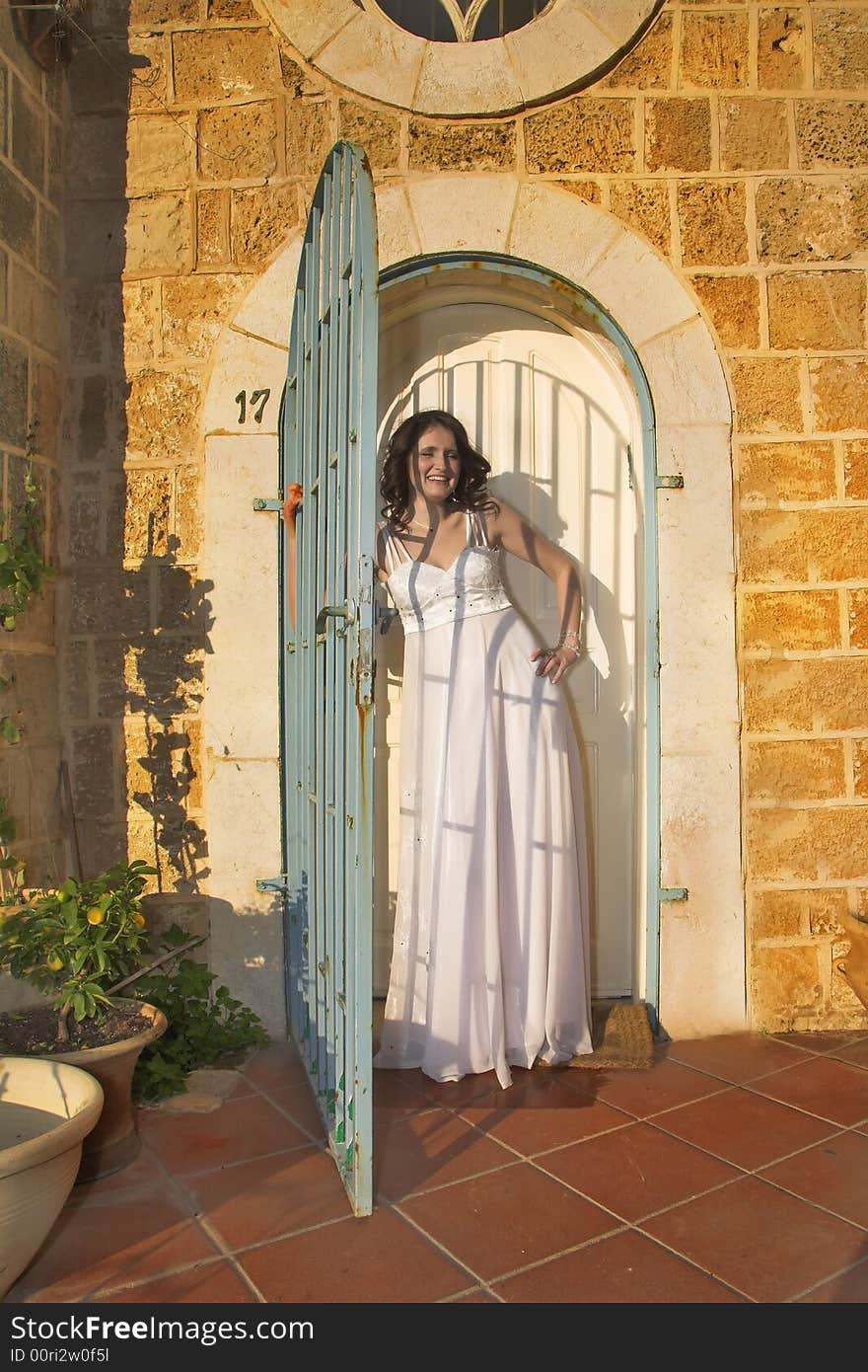 The beautiful bride in a white dress on a background of ancient walls of ancient city. The beautiful bride in a white dress on a background of ancient walls of ancient city