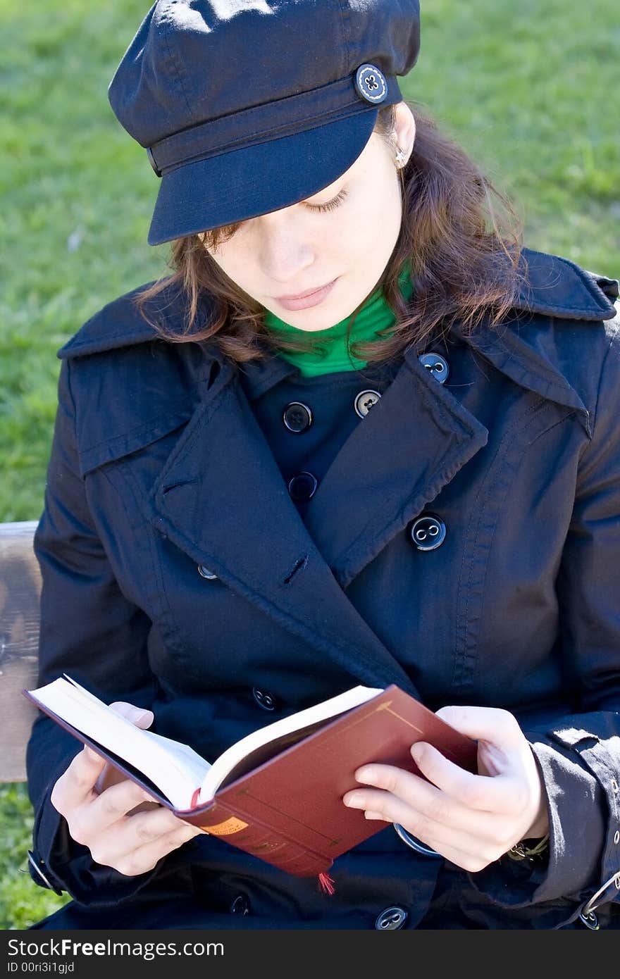 Young woman enjoying a book in the park. Young woman enjoying a book in the park