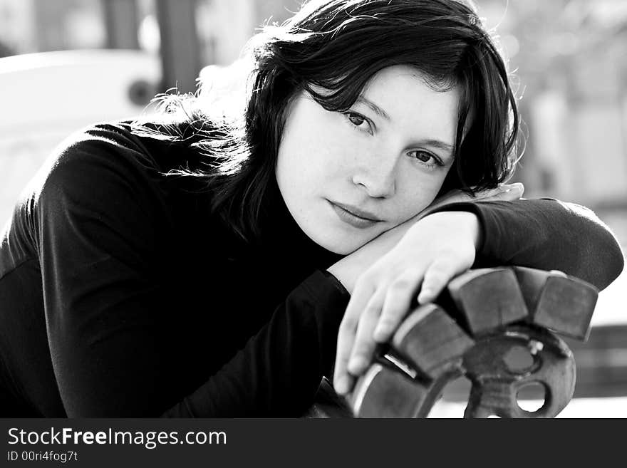 Black and white portrait of good looking woman in bench. Black and white portrait of good looking woman in bench