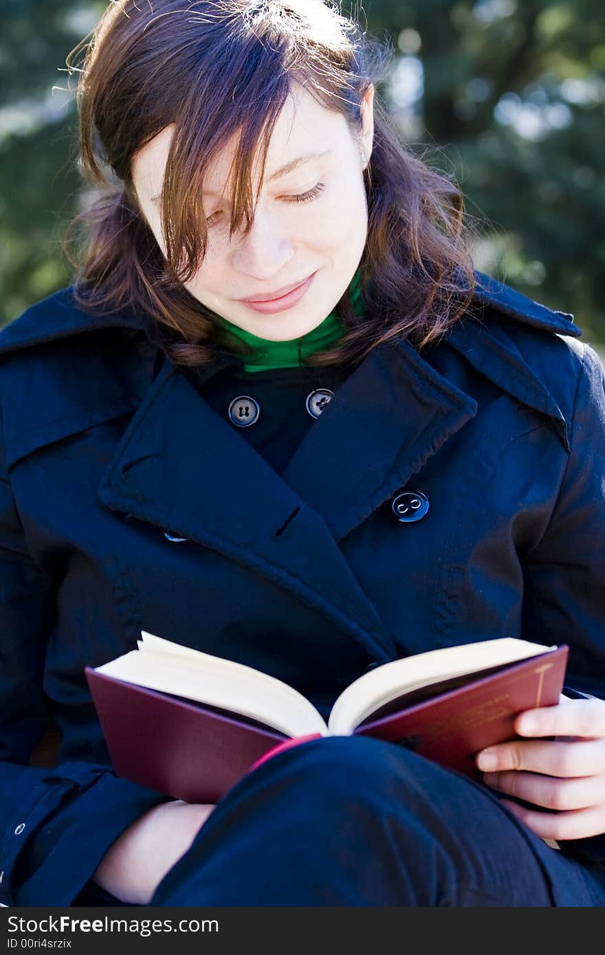 Young woman enjoying a book in the park. Young woman enjoying a book in the park