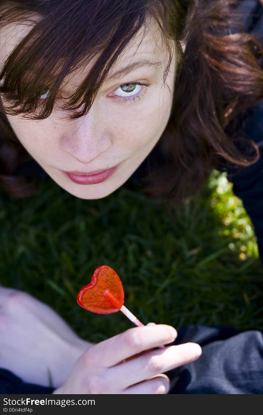 Young woman with red candy in her hands. Young woman with red candy in her hands