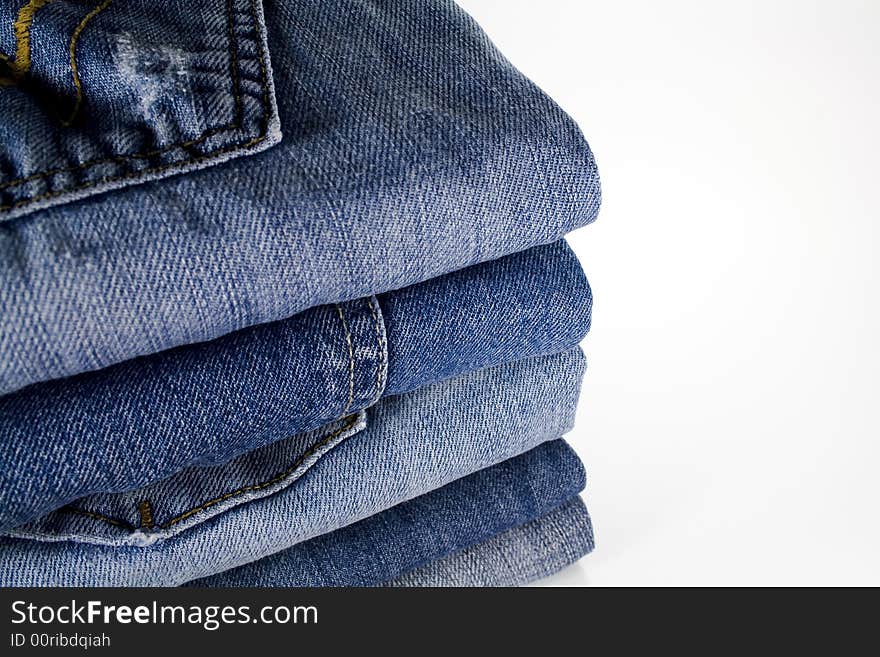 Stack of jeans over white