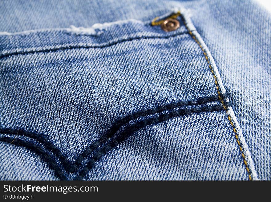 Pocket of blue jeans close up