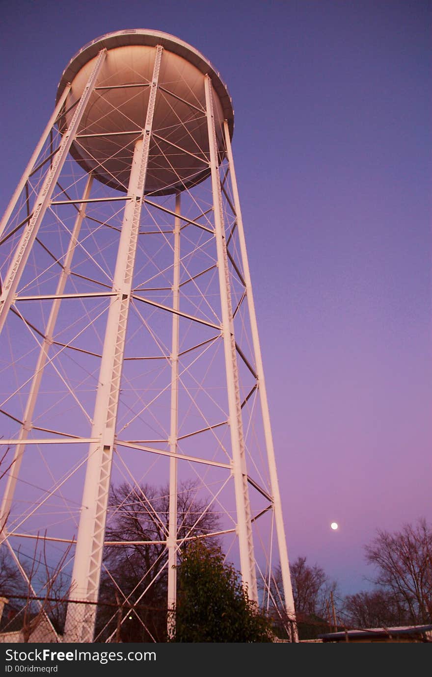 Water tower at sunset shot from below with wide angle.