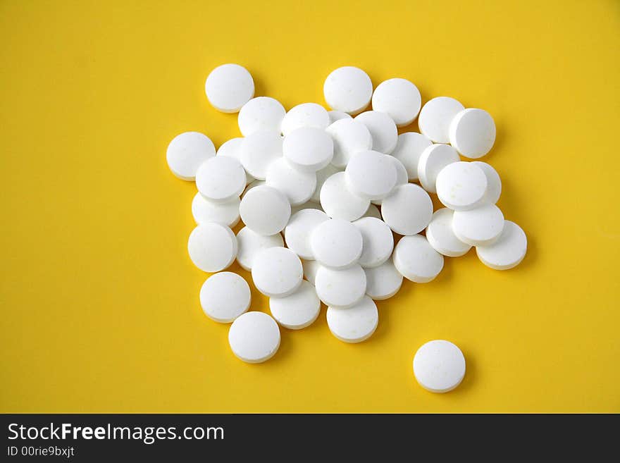 Pills isolated on yellow background. Pills isolated on yellow background.