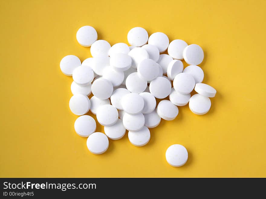 Pills isolated on yellow background. Pills isolated on yellow background.