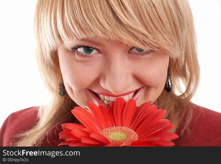 A smiling green-eyed woman in red with red flowers