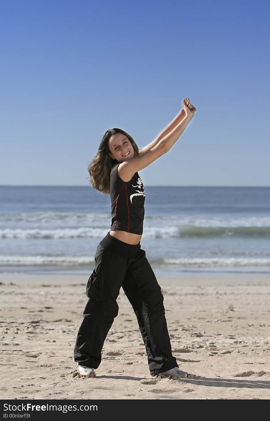 Woman stretching at the beach