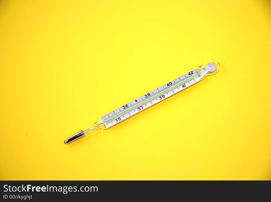 Medicine thermometer  isolated on the yellow background. Medicine thermometer  isolated on the yellow background.