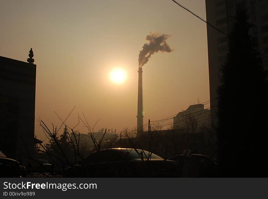 The declining sun; the setting sun chimney stack smokestack sun