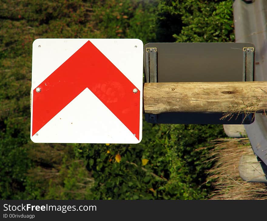 Street sign showing direction on a wooden pole