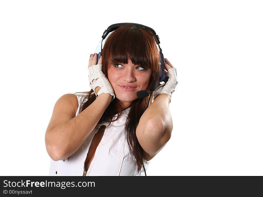 The young girl in headphones with a microphone listens to music