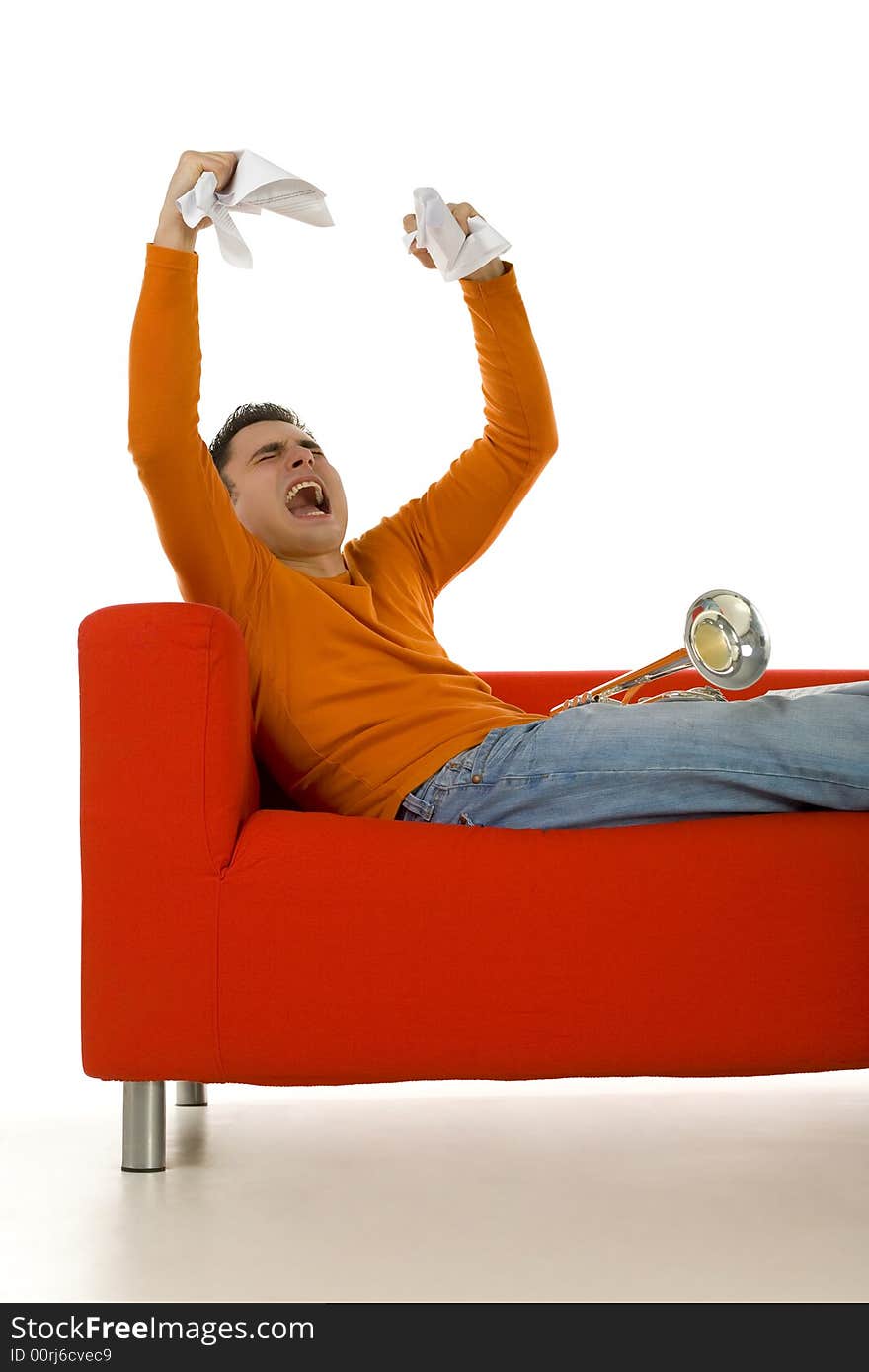 Furious trumpeter sitting on red couch and screaming with hands rising up. White background. Furious trumpeter sitting on red couch and screaming with hands rising up. White background.