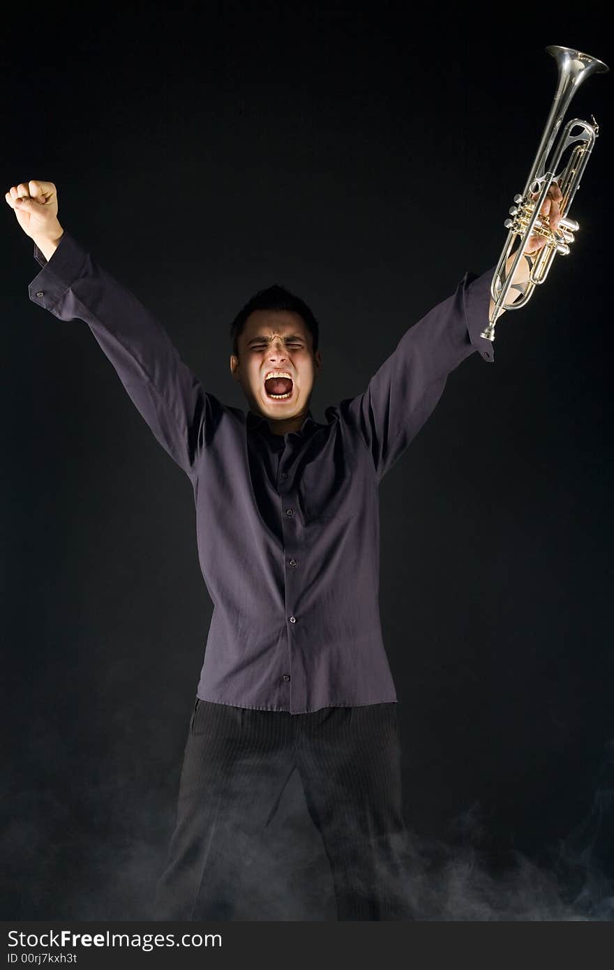 Excited man standing with trumpet in hand and screaming. Front view. Excited man standing with trumpet in hand and screaming. Front view.