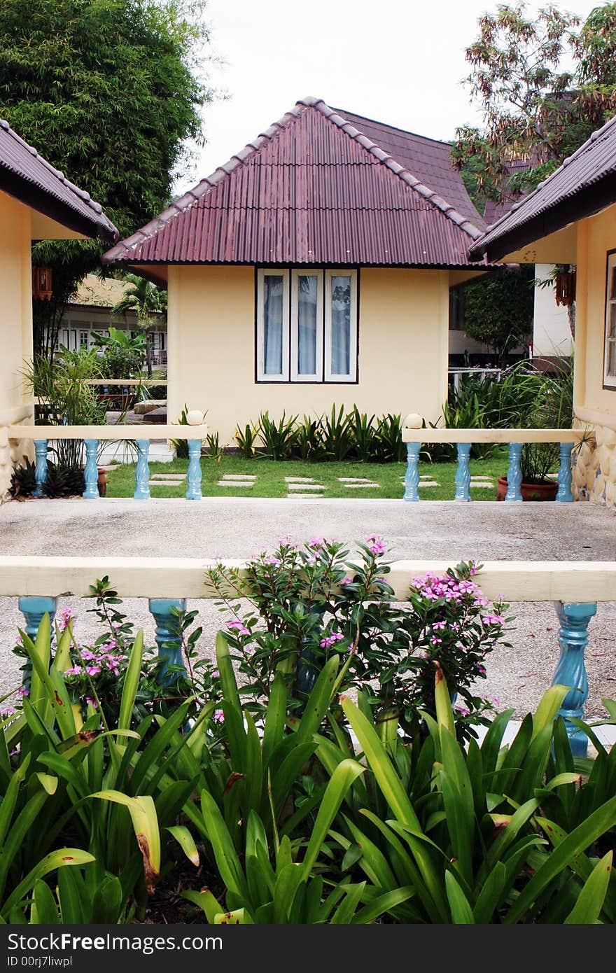 Exterior of bungalows and a garden.