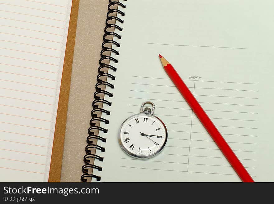 The note book with hours and a red pencil. The note book with hours and a red pencil