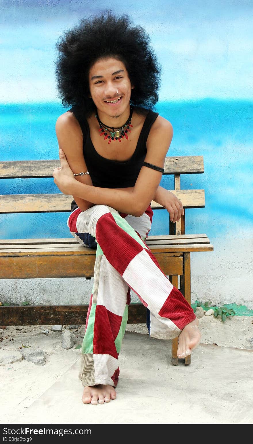 Young happy Thai man with an afro.