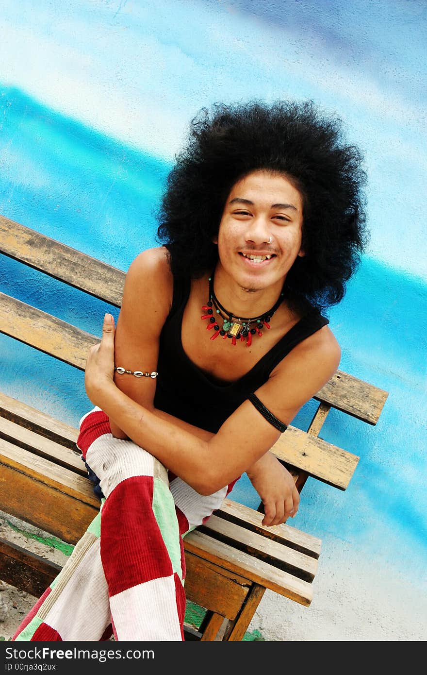 Young happy Thai man with an afro.