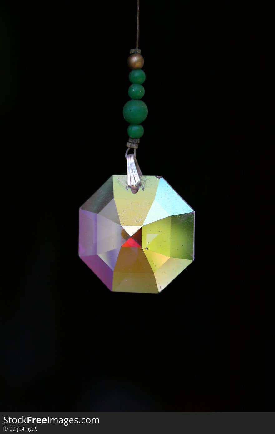 A sun catcher crystal isolated on black background